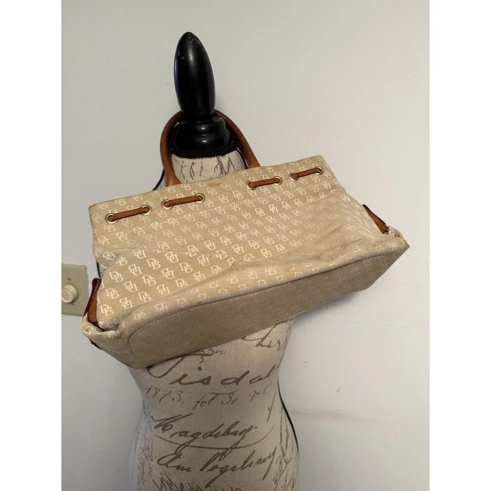 Dooney and Bourke Beige Canvas and Leather Signature Tassel Tote Handbag‎